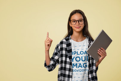 T-Shirt Mockup Featuring a Girl With Glasses Holding a Tablet