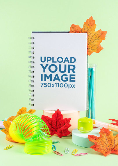 Notebook Mockup Featuring Autumn Leaves and a Slinky Toy m28738 r-el2
