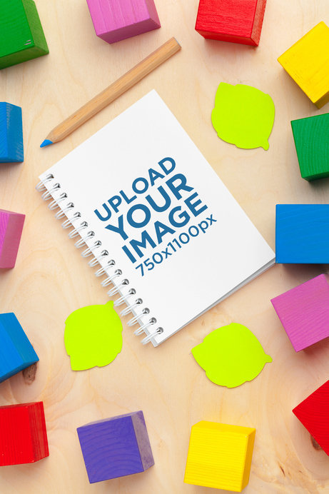 Mockup of a Notebook Surrounded by Colorful Blocks