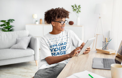 Round-Neck Tee Mockup of a Smiling Teenager Taking Online Classes