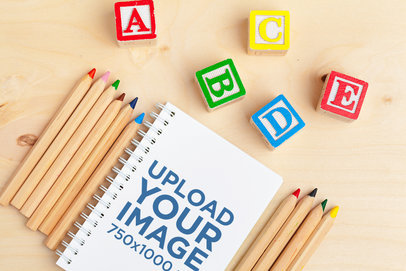 Notebook Mockup Featuring Colorful Letter Blocks and Wooden Pencils