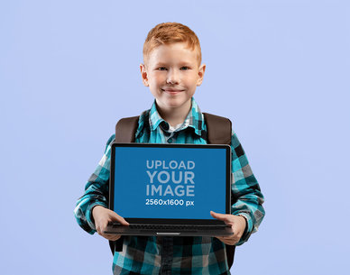 Mockup of a Boy Holding a MacBook at a Studio m28728 r-el2