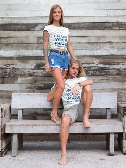 Blonde Couple Wearing Tshirts Mockup on a Wooden Bench
