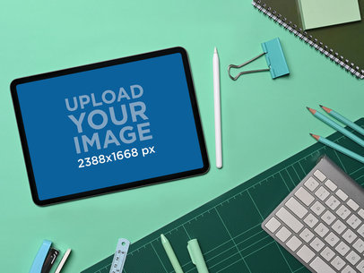 Mockup of an iPad Placed Over a Green Background Surrounded by School Supplies m20180 r-el2