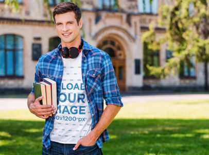 T-Shirt Mockup Featuring a Man Holding Books at a School
