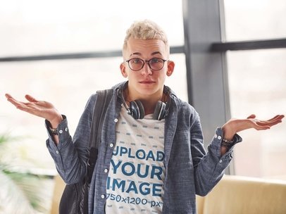 V-Neck Tee Mockup of a Young Man with Glasses Shrugging His Shoulders