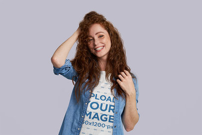 T-Shirt Mockup Featuring a Happy Redheaded Woman at a Studio