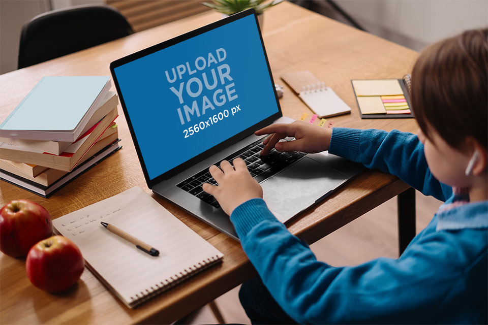Mockup of a Boy Doing Homework on a MacBook