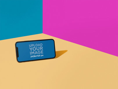 iPhone X Mockup in Landscape Position Near a Tricolor Corner a19721