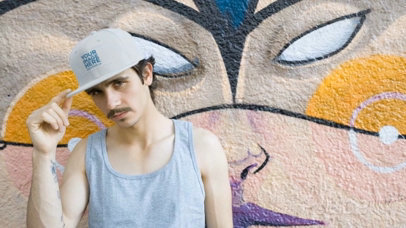Hipster Man with Mustache Wearing a Snapback Hat Video Near a Graffiti a14160