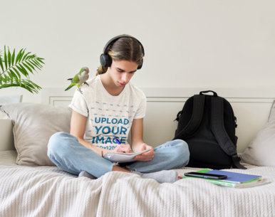 Heathered Tee Mockup of a Teenager with Headphones Doing Homework 