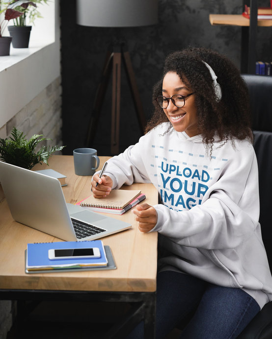 Hoodie Mockup Featuring a Young Woman Taking an Online Class