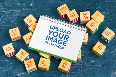 Mockup of a Notebook Placed on Top of Some Blocks