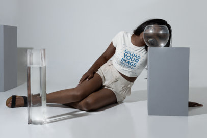 Crop Top Tee Mockup of a Woman Sitting Looking Through a Fish Tank m28404