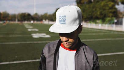Trendy Guy Wearing a Hat in Stop Motion at a Football Field a13695