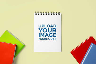 Mockup of a Notebook Placed on a Customizable Background Surrounded by Books m28681 r-el2