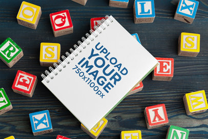 Spiral Notebook Mockup Featuring Alphabet Blocks 