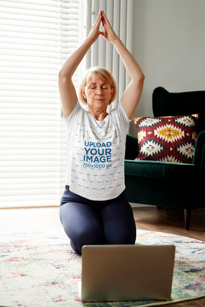 Round-Neck Tee Mockup of an Elderly Woman Doing Yoga at Home