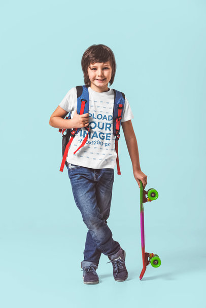 T-Shirt Mockup Featuring a Happy Boy Holding a Skateboard