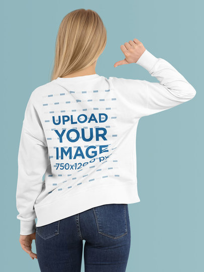 Back-View Mockup of a Woman Pointing at Her Sweatshirt