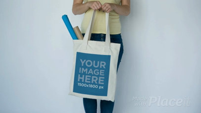 Girl Slightly Swinging a Tote Bag Standing Against a White Wall Video a13847