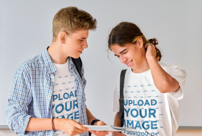 Round-Neck T-Shirt Mockup of Two Students with a Notebook Standing by a Whiteboard