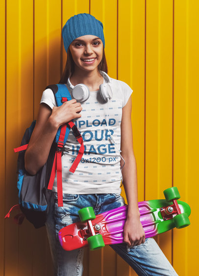 Round-Neck Tee Mockup of a Teenage Girl with a Backpack Holding a Skateboard