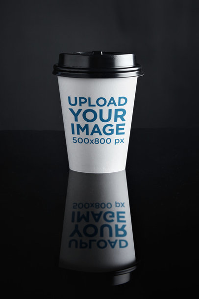Mockup of a Coffee Cup Placed on a Dark Setting