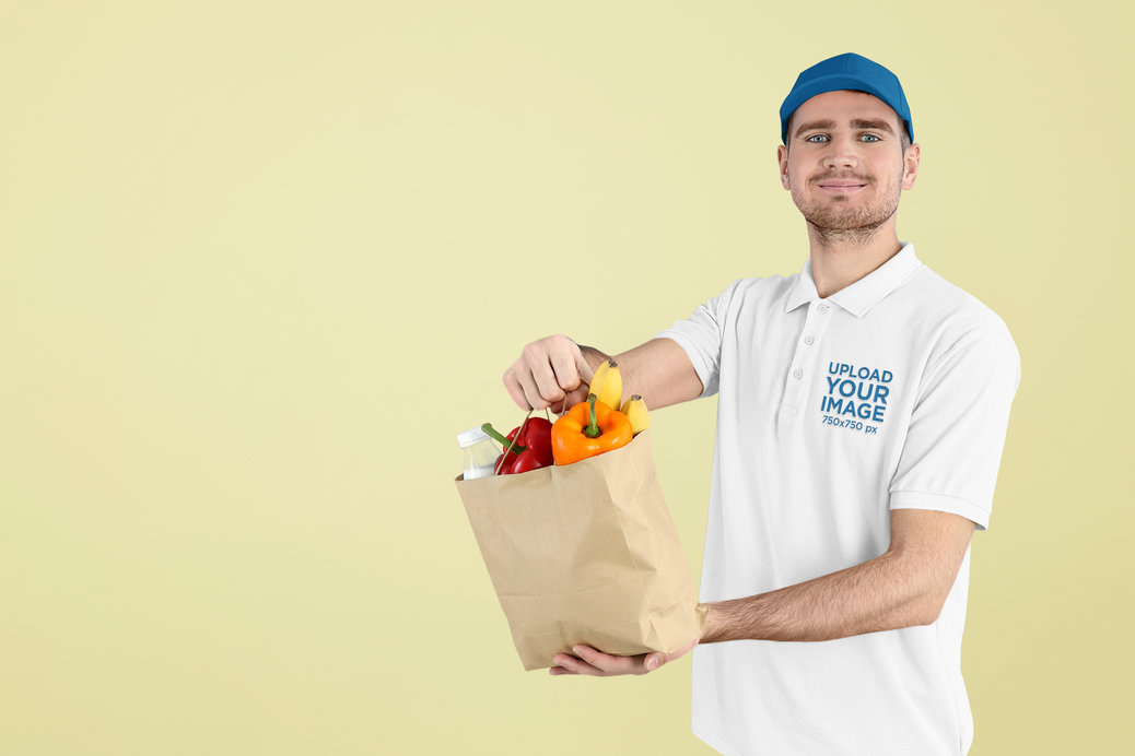 Polo Shirt Mockup of a Man Holding a Bag of Fruit