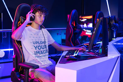 Bella Canvas T-Shirt Mockup Featuring a Man at a Gaming Center