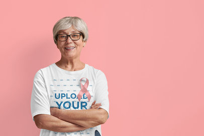 T-Shirt Mockup Featuring a Senior Woman for a Supporting Breast Cancer Awareness Campaign