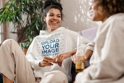 Pullover Hoodie Mockup of a Joyful Woman Talking with a Friend at Home