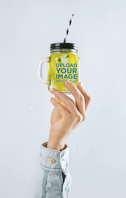 Mockup of a Hand Holding a Mason Jar with a Straw