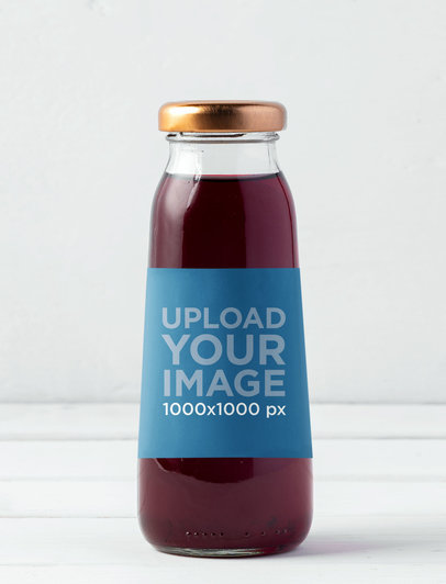 Mockup of a Glass Bottle with Juice Against a White Background