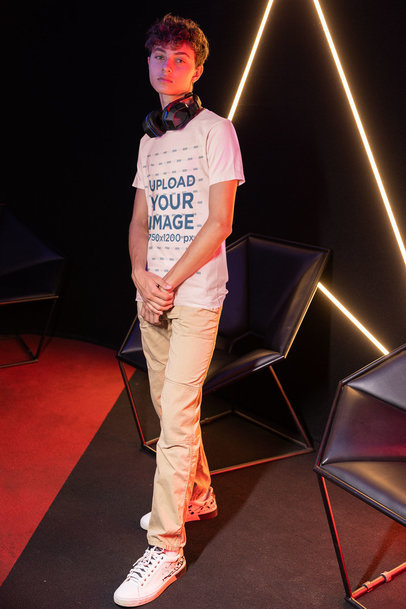 Mockup of a Man With a T-Shirt and Headphones Posing at a Gamer's Arena