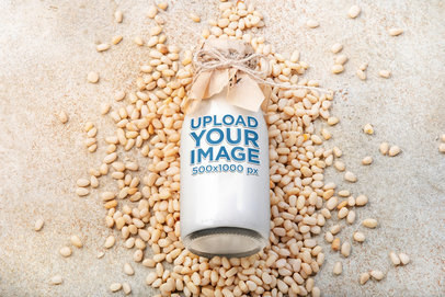 Mockup of a Glass Bottle Placed on Some Pine Nuts  m29280 r-el2