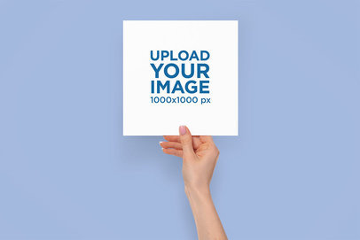 Mockup of a Woman's Hand Holding a Squared Flyer