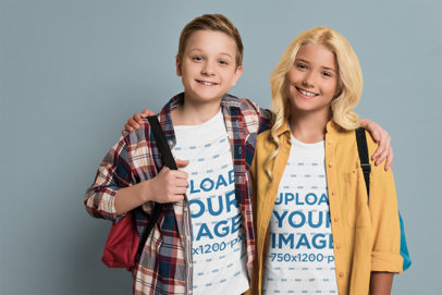 T-Shirt Mockup Featuring Two Teenagers Posing at a Studio