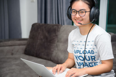 Heathered Tee Mockup of a Happy Female Teacher Giving Using a Laptop at Home