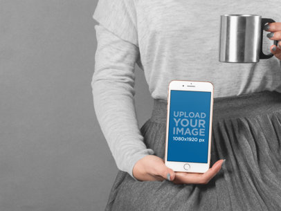 Woman Holding an iPhone Mockup and a Metal Cup