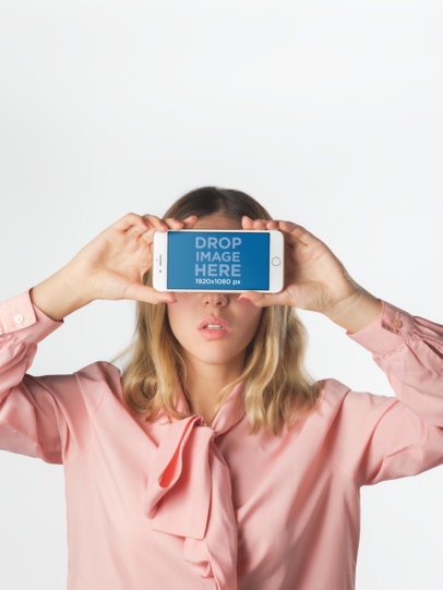 Girl Holding an iPhone Mockup Against her Face Against White Background a19290