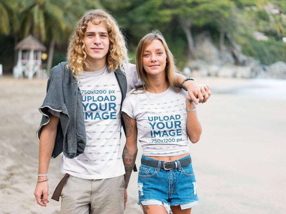 Surfer Couple Wearing Tshirts Mockup Walking on the Beach