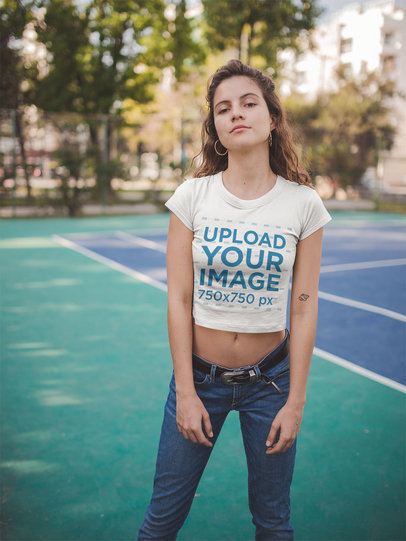Beautiful Woman Wearing a Crop Top Tee Mockup on a Tennis Court