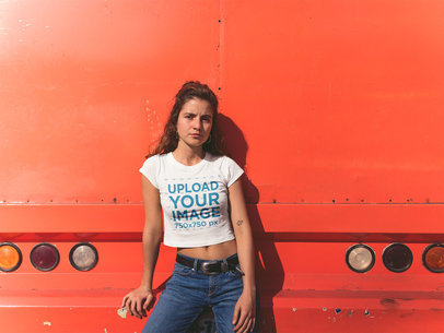 Woman Wearing a T-Shirt Mockup Against the Back of an Orange Truck