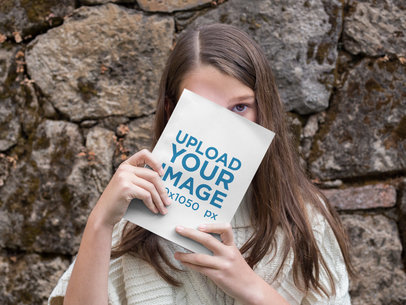 Girl Hiding Behind a Book Mockup Outdoors
