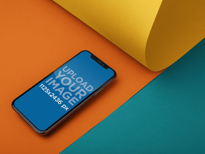 iPhone 11 Pro Mockup Lying on Three Pasteboards