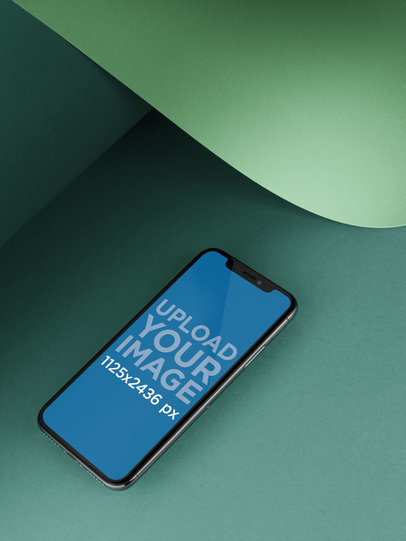 iPhone 11 Pro Template Lying Below a Bent Pasteboard