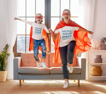 T-Shirt Mockup of a Daughter and Her Mom in Matching Superhero Outfits