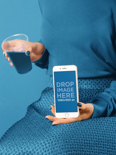 Woman Holding an iPhone 8 Mockup and a Glass of Liquid a19244