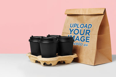 Mockup of a Paper Bag Placed Next to Some Coffee Cups